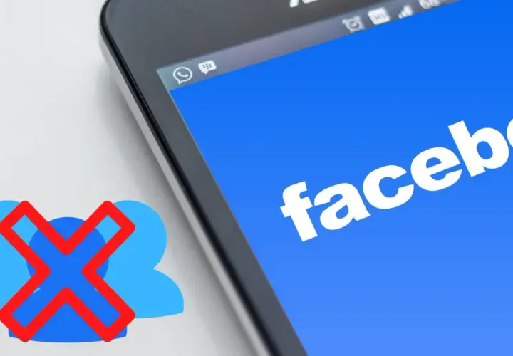 Chcesz wiedzieć, jak usunąć grupę na FB? Ikona z przekreślonymi ludzikami obok ekranu telefonu z logo Facebooka sugeruje rozwiązanie.